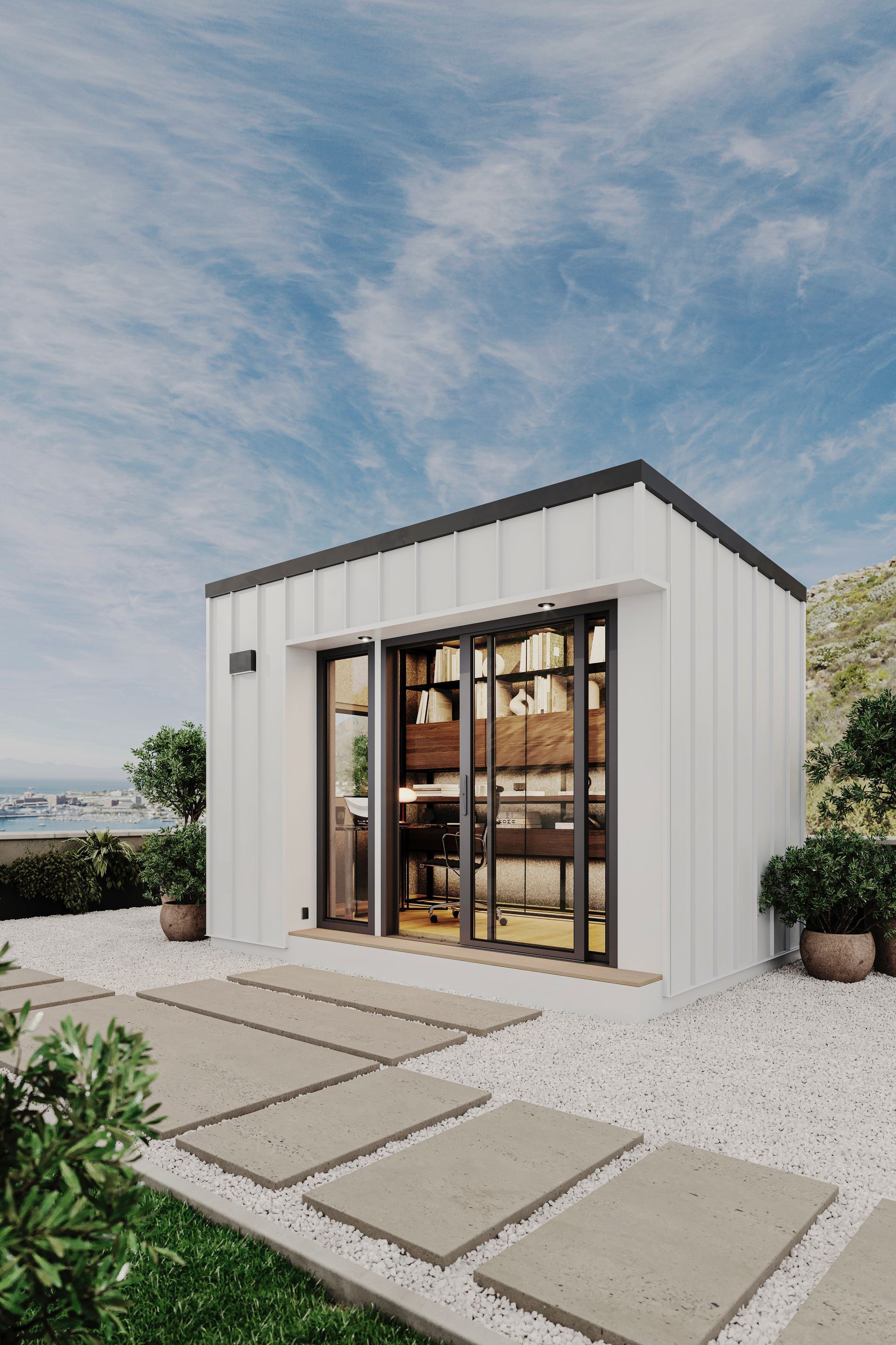 A modern white house with a lot of windows and a walkway leading to it