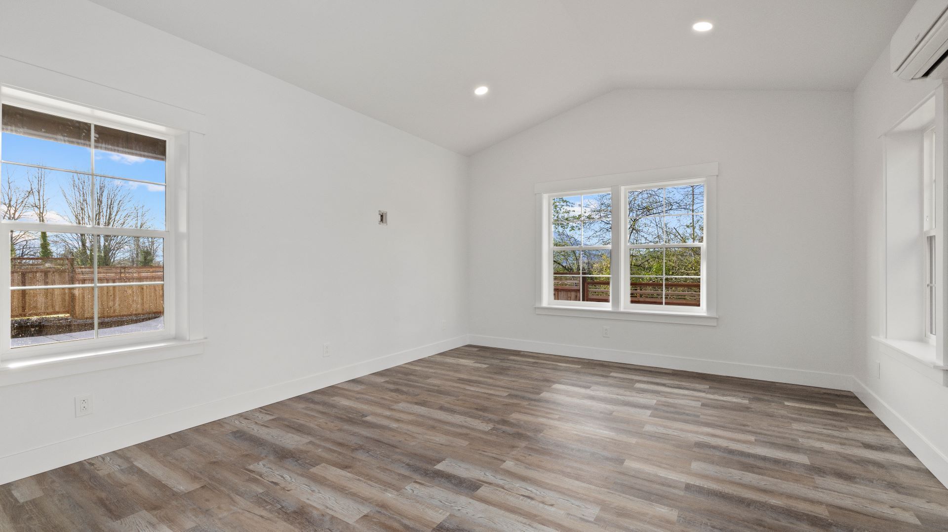 An empty living room with hardwood floors