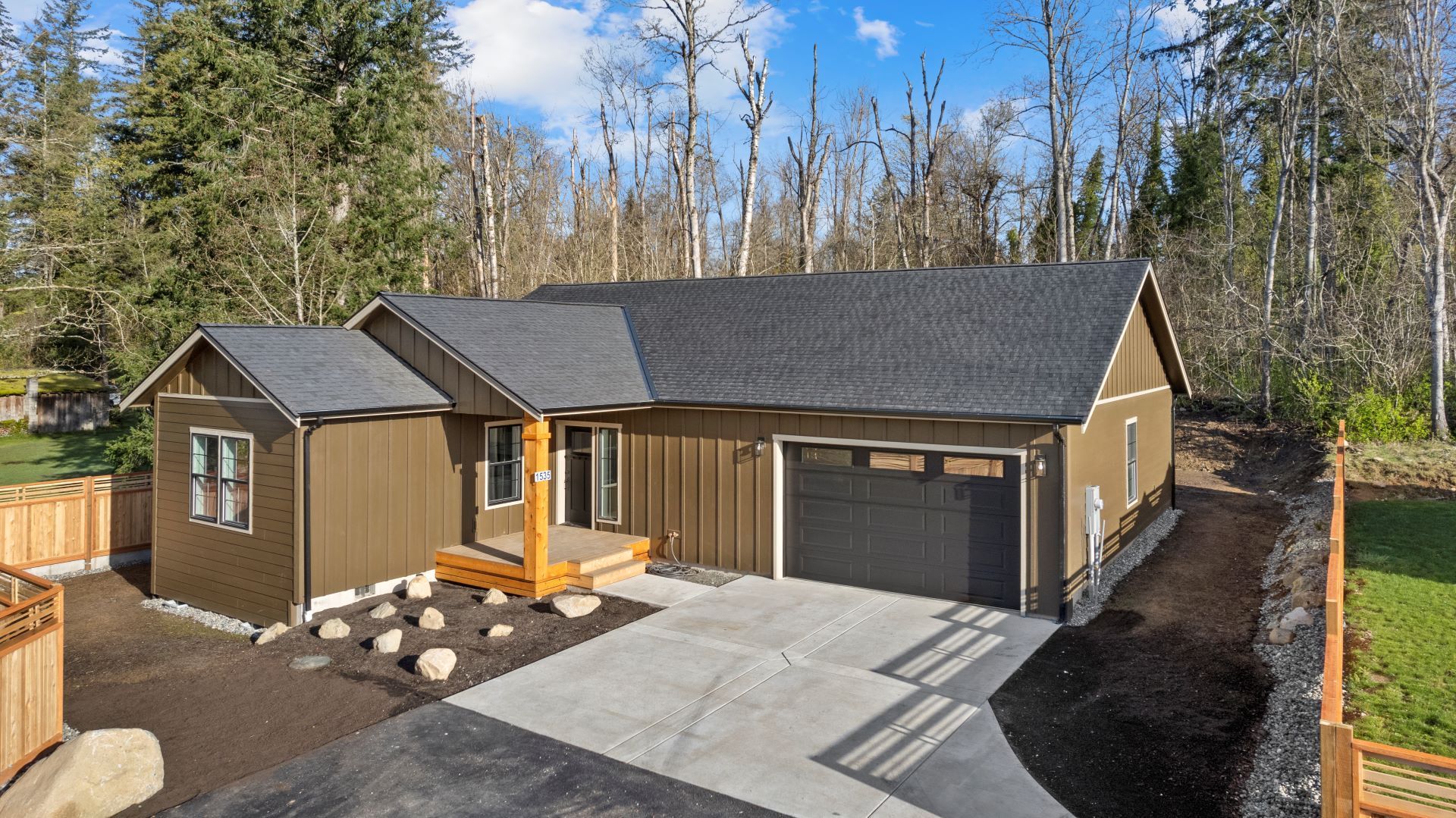 An aerial view of a house with a garage and a driveway.