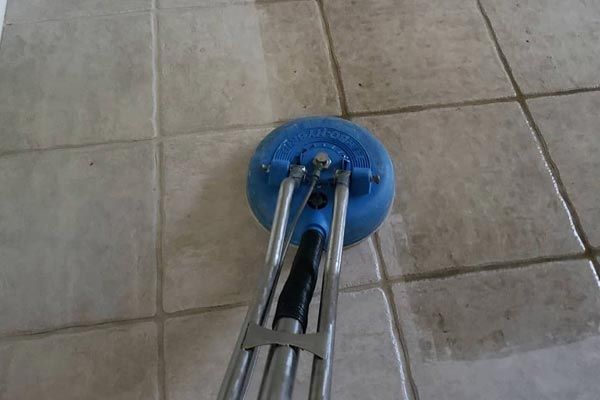 a tile floor is being cleaned with a machine