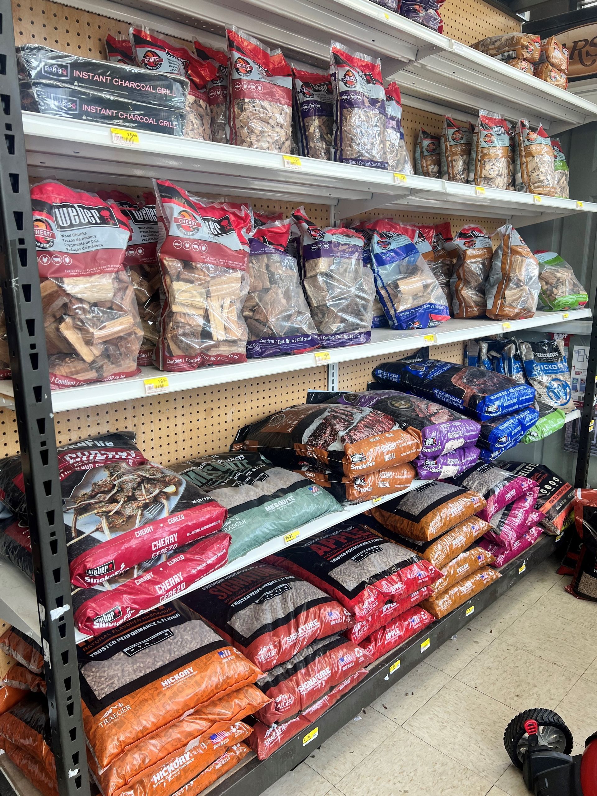 A store shelf filled with bags of hardwood pellets