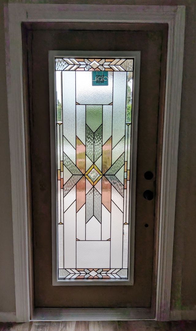 Front door with frosted stained glass panel in geometric floral design