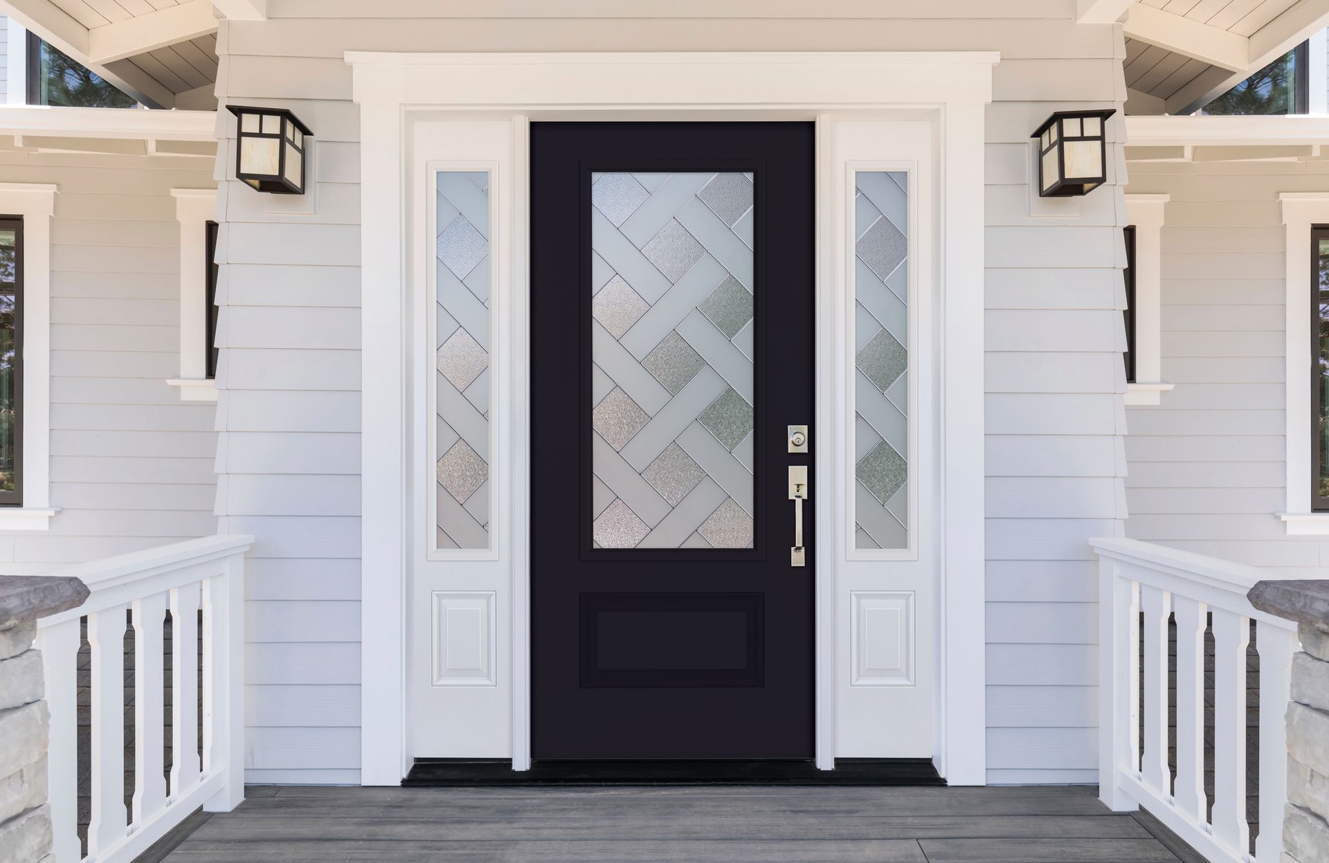 A modern black front door with a decorative woven-pattern glass window, flanked by white sidelights on a light blue porch.
