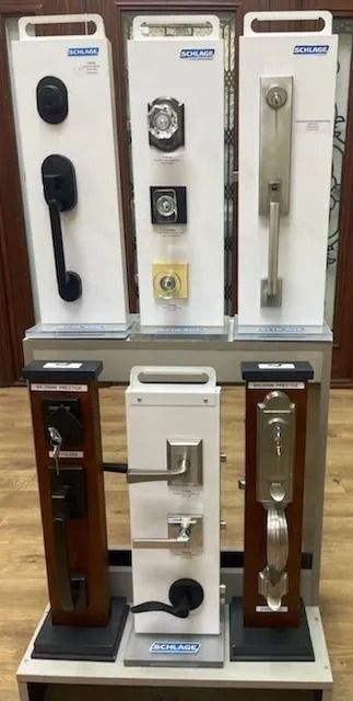 Display of door hardware samples on a store rack; various styles, finishes, and configurations.