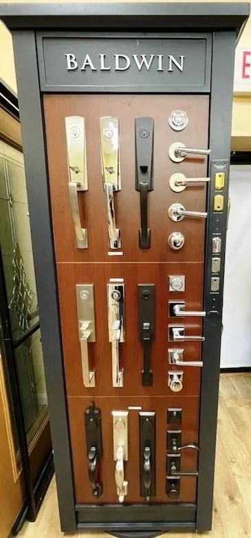Baldwin door hardware display featuring various handle styles and finishes.