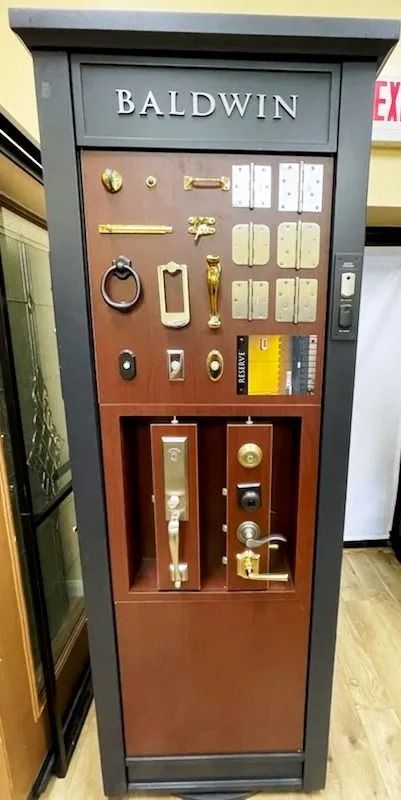 Baldwin hardware display with door knobs, handles, and other hardware samples.