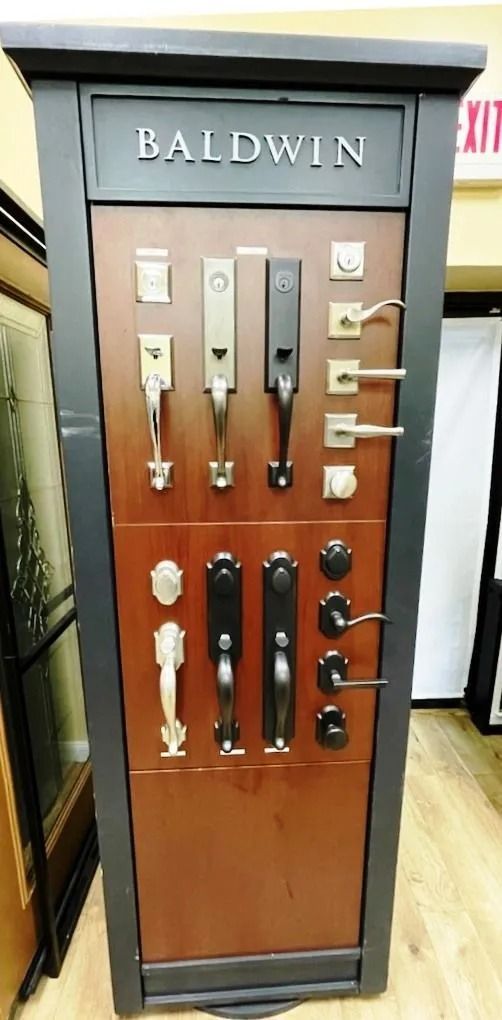 Baldwin door hardware display featuring various handle and lock styles.