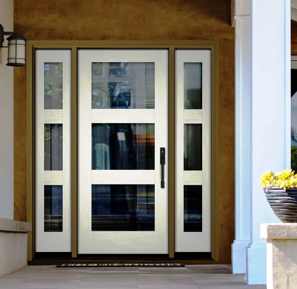White front door with sidelights, black hardware, and welcome mat.