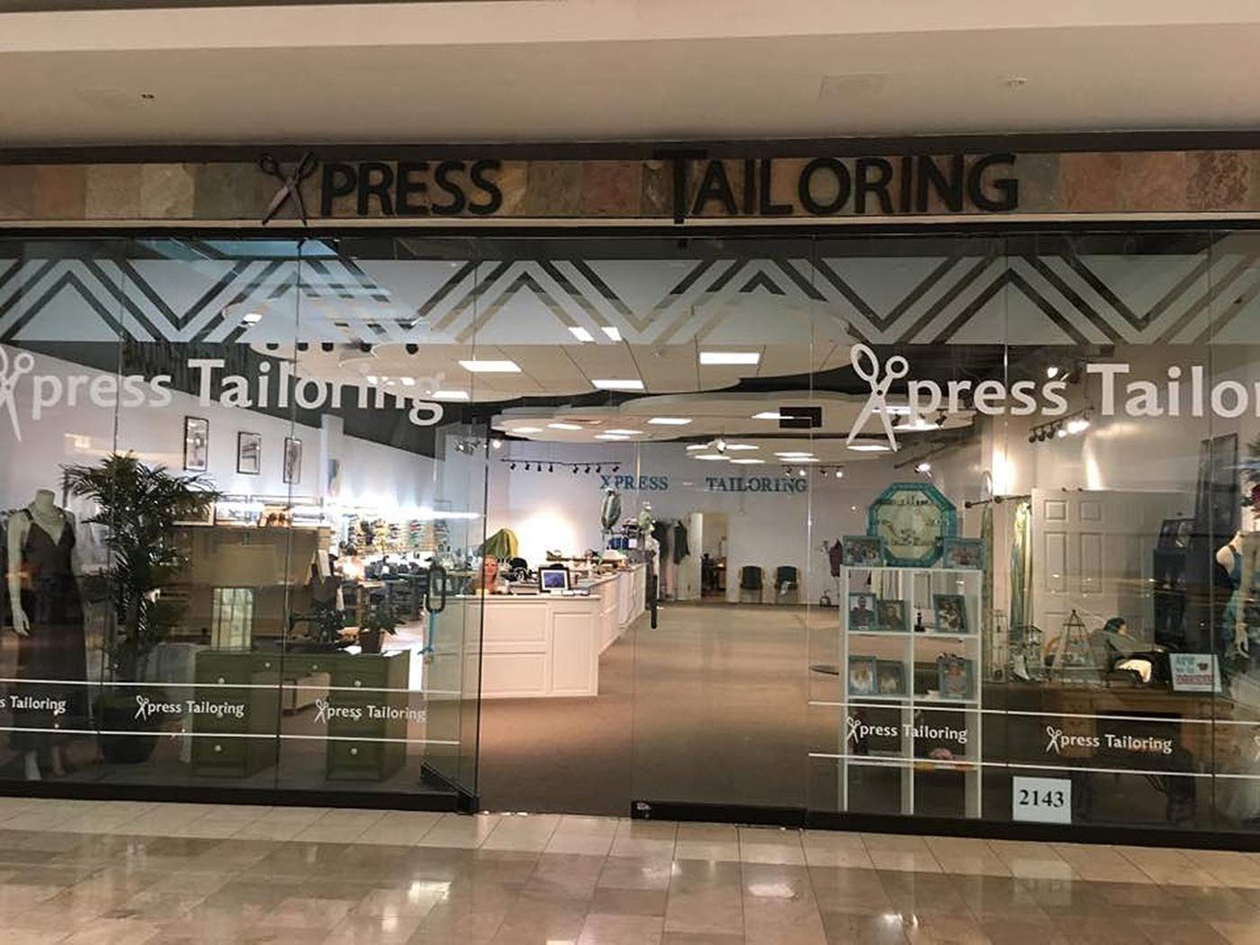 The front of a tailoring shop in a mall.