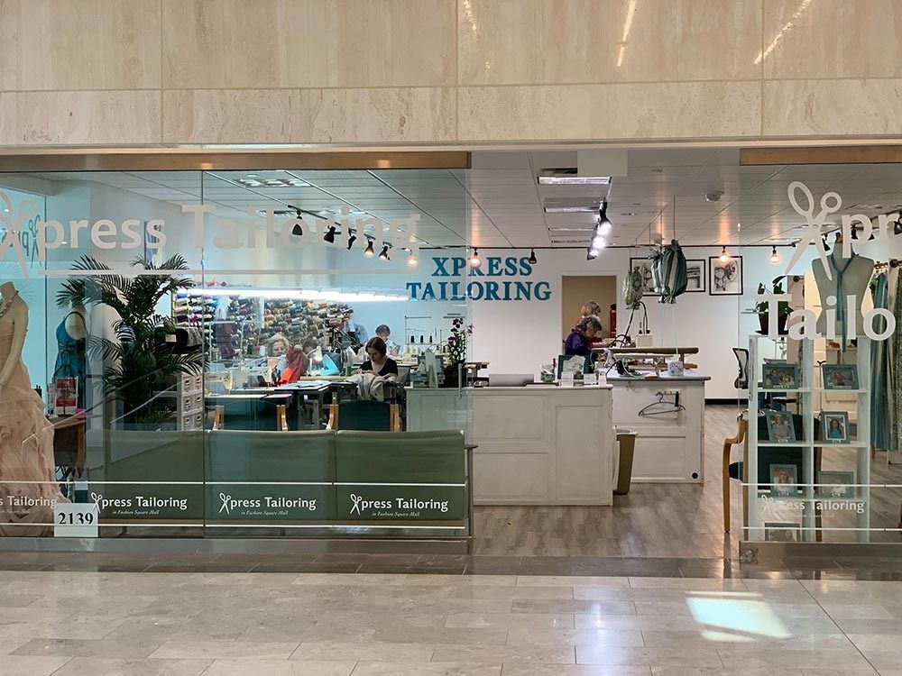 A tailoring shop is located in a shopping mall.