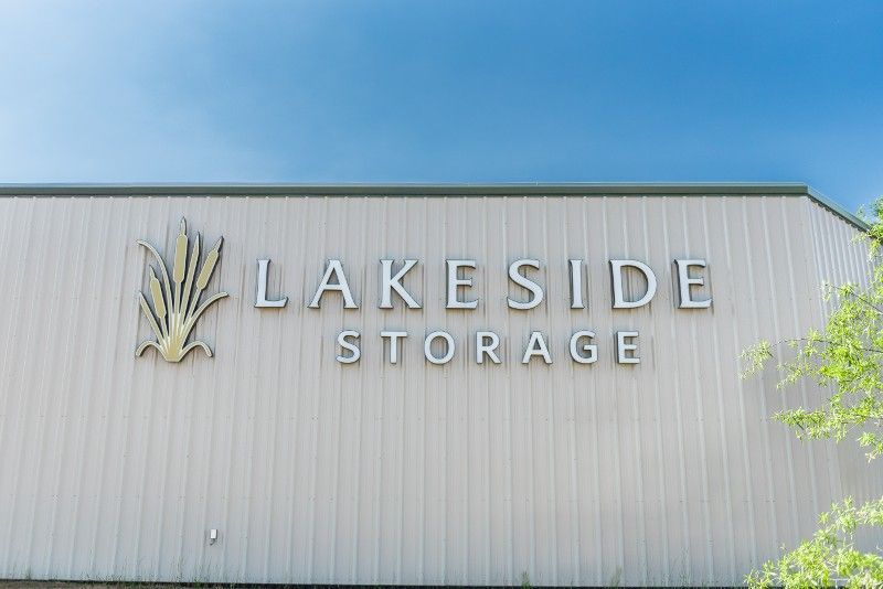 A large sign on the side of a building that says lakeside storage.