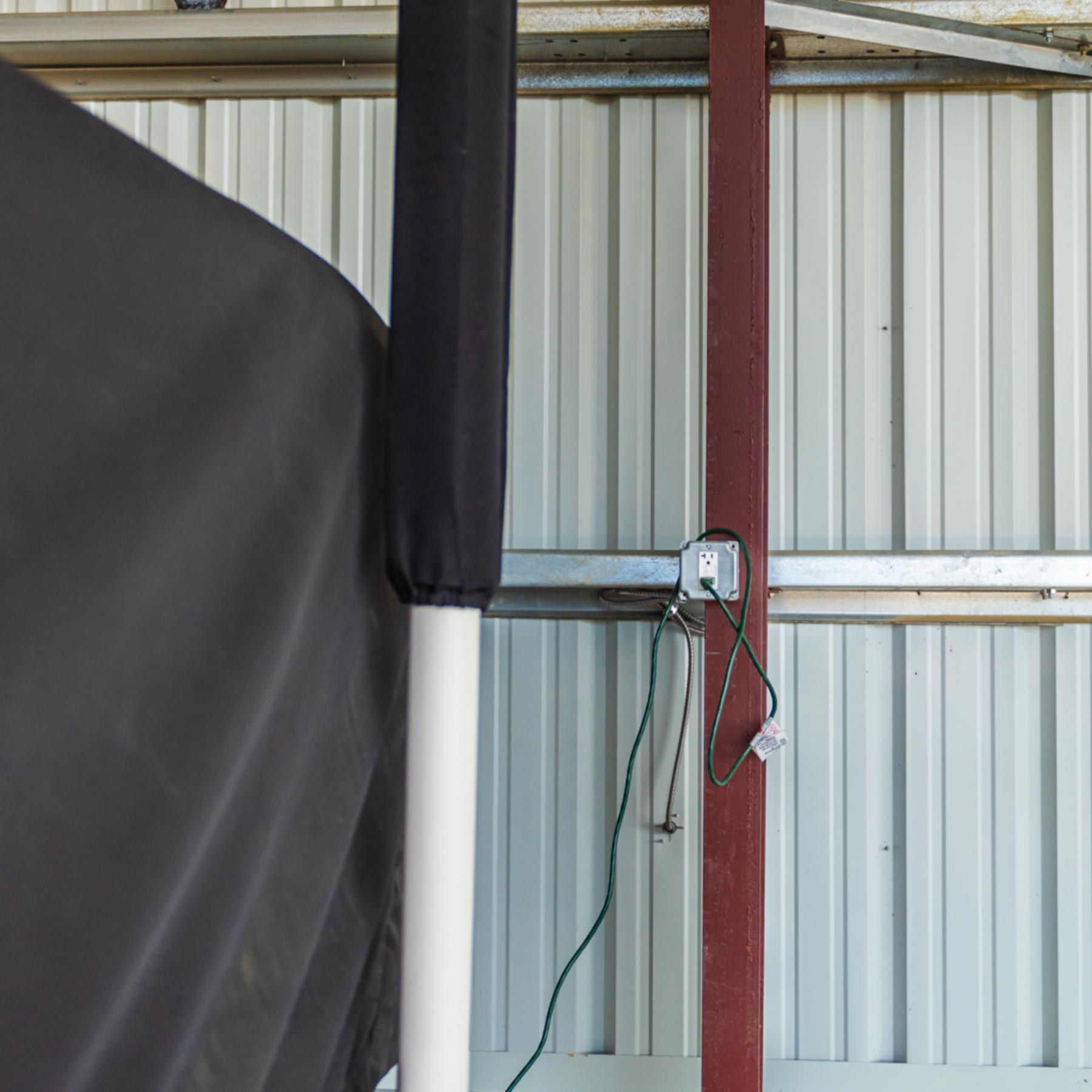 A black cover is covering a pole in a building