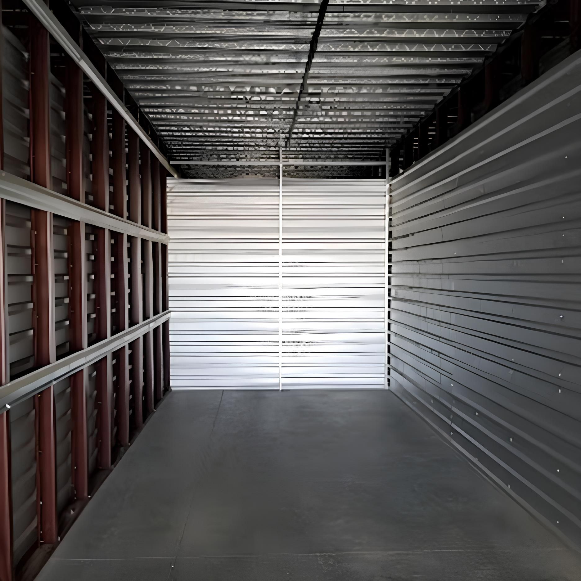 A large empty room with a metal wall and ceiling