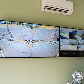 A room with a lot of security cameras on the wall.