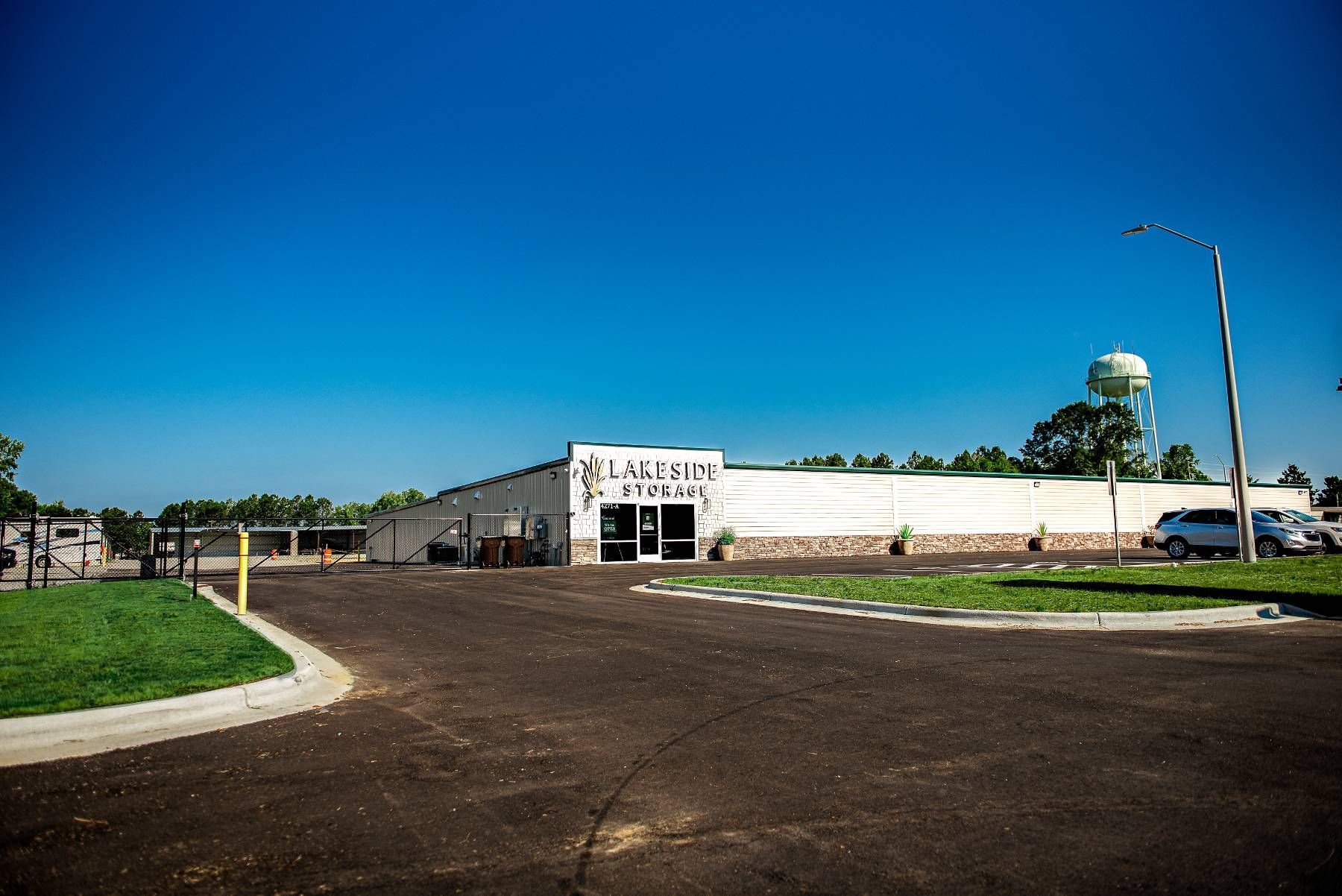A large white building with a wide parking space