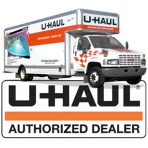 A uhaul truck is sitting next to a sign that says authorized dealer