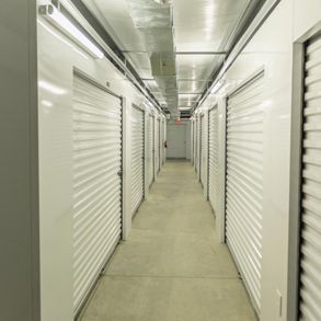 A long hallway filled with rows of white shuttered doors.