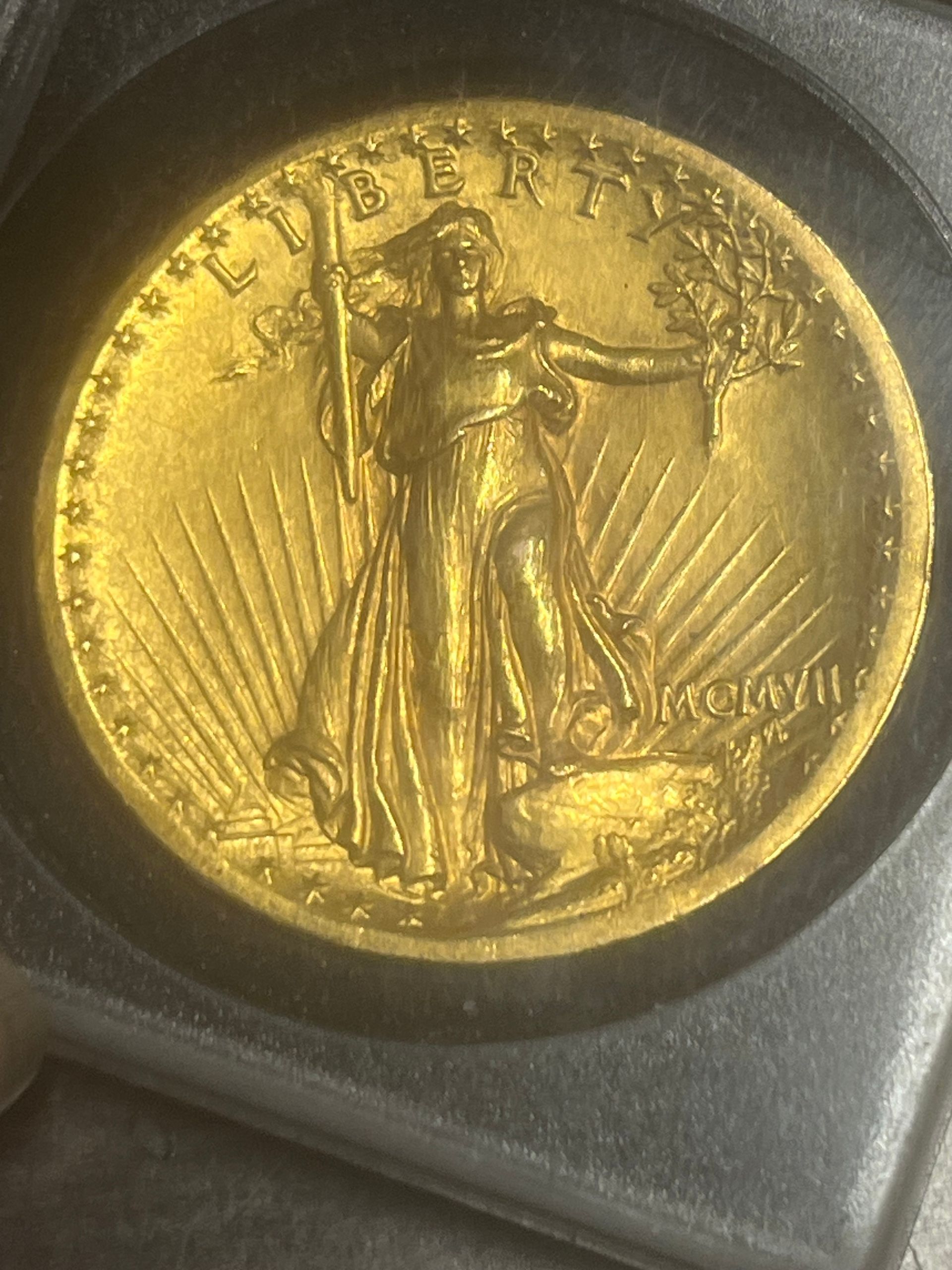 A gold Saint-Gaudens double eagle coin featuring a walking Lady Liberty carrying a torch and olive branch.