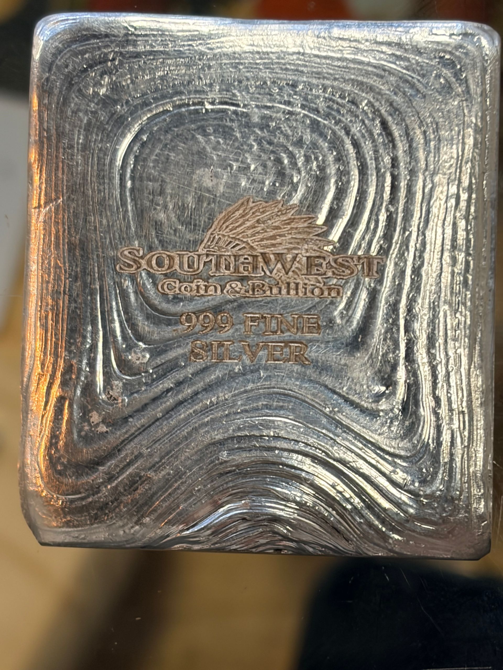 A Southwest Art Bullion hand-poured silver bar with a wavy, textured surface and metallic finish.