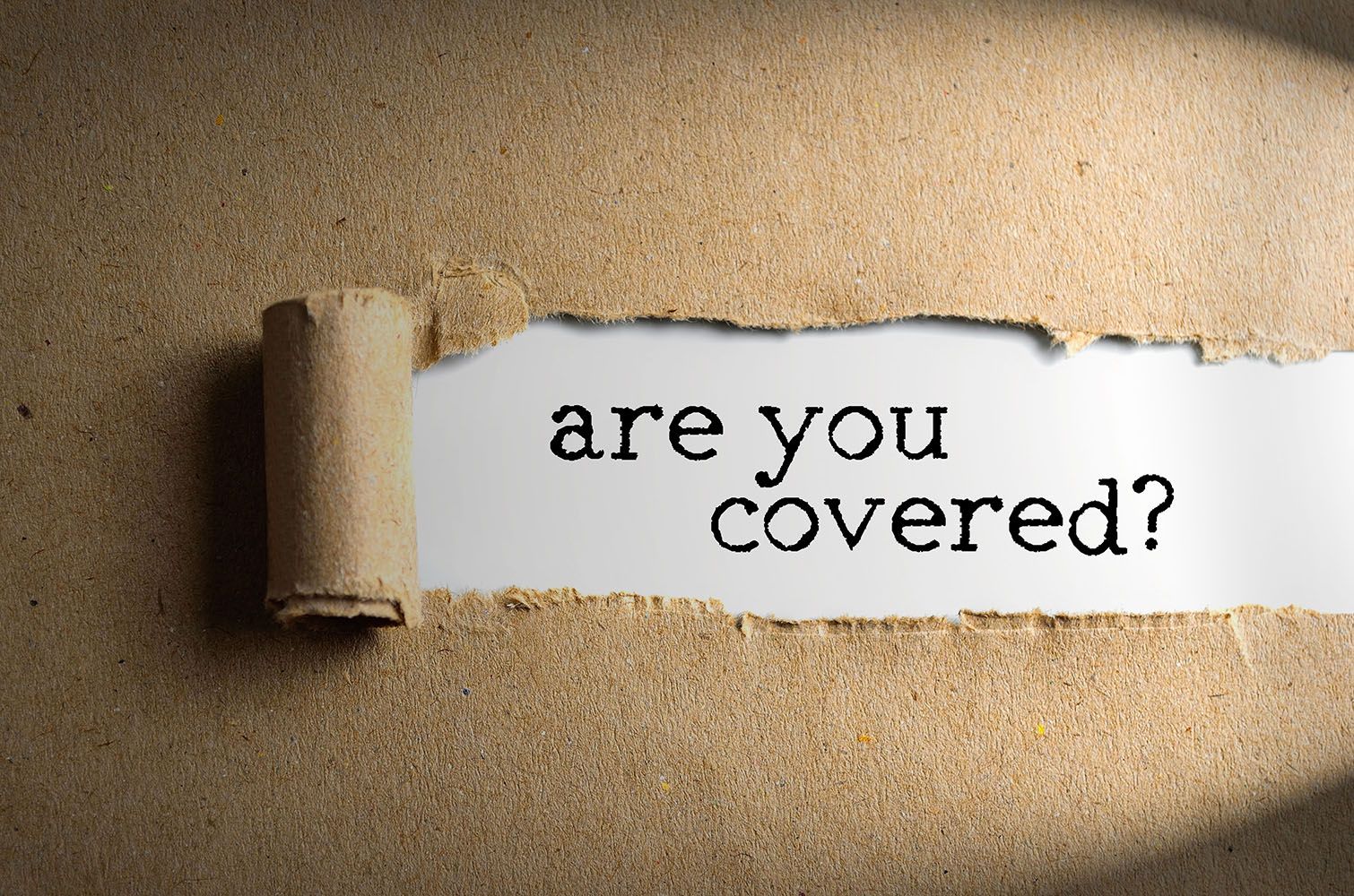 A torn piece of paper with the words are you covered written on it
