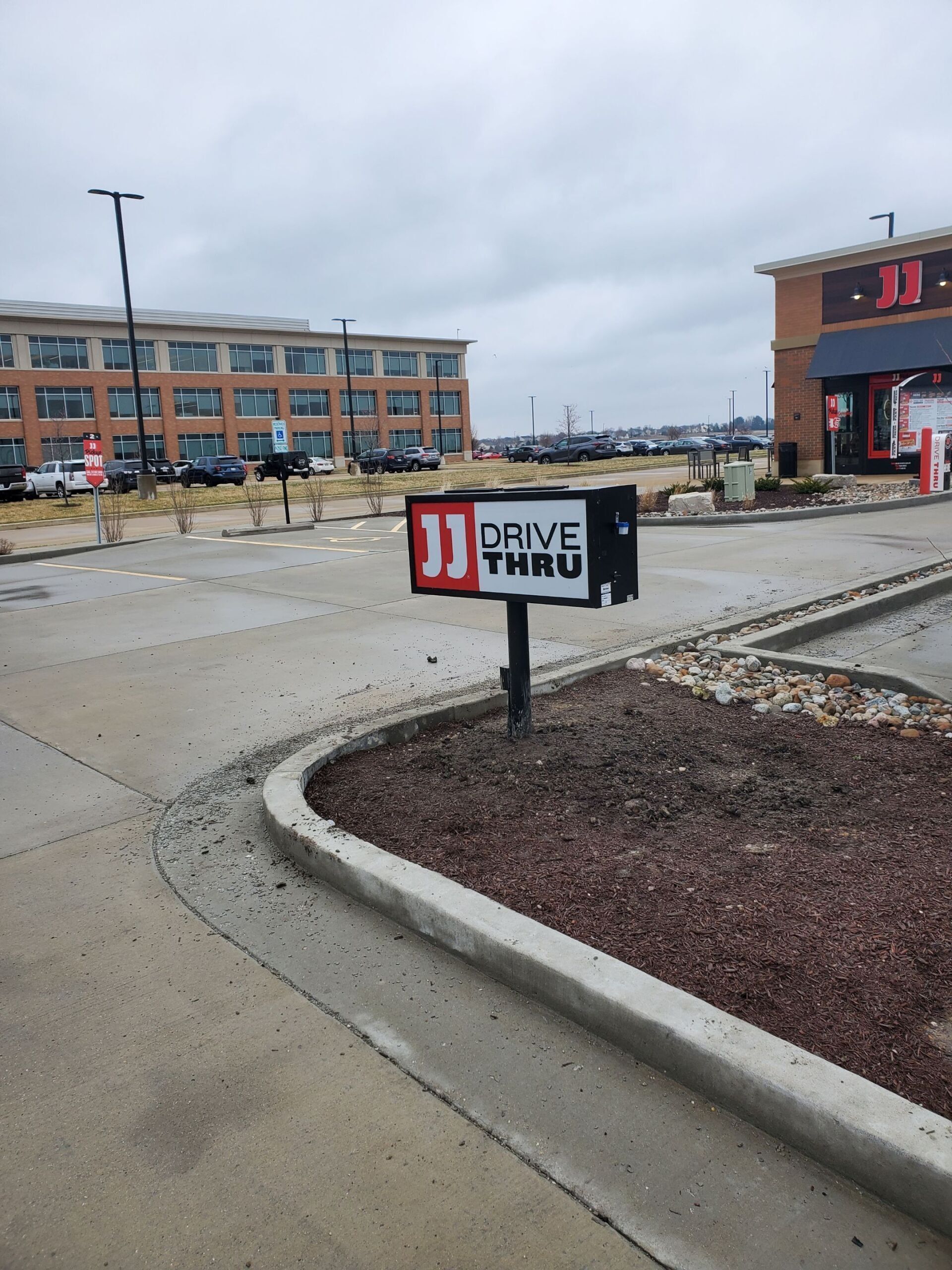 A drive thru sign in a parking lot
