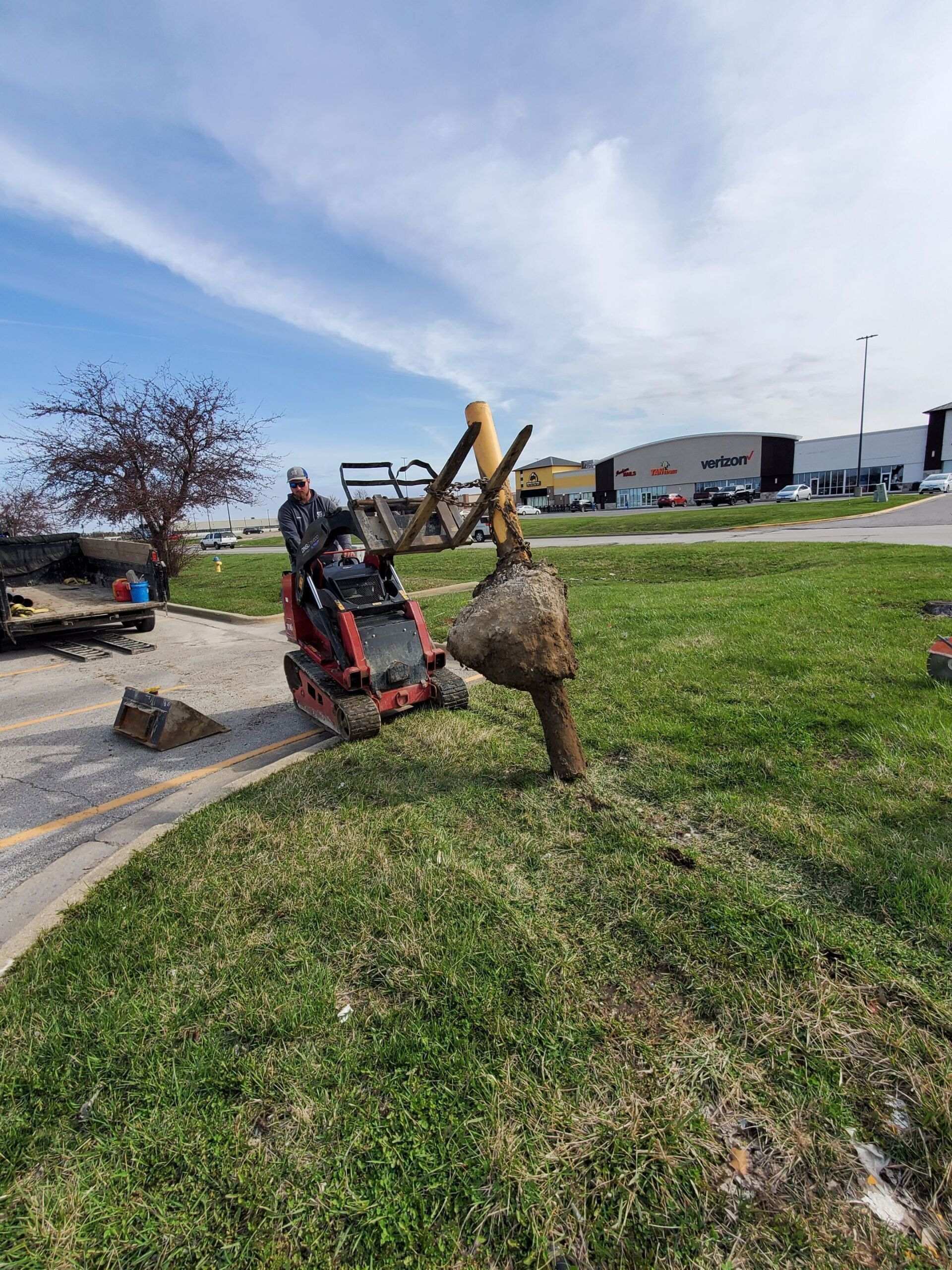 A man is driving a tractor in a grassy field.