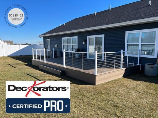 A blue house with a deck that is decorators certified pro