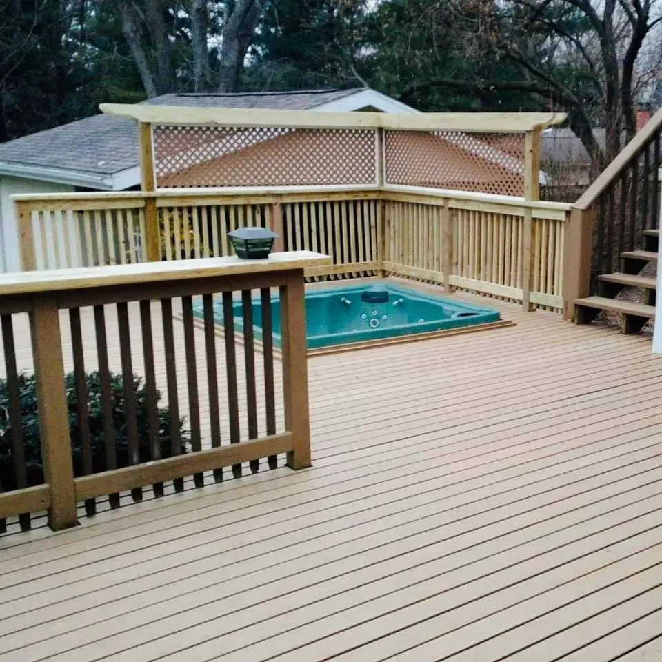 A wooden deck with stairs and a hot tub