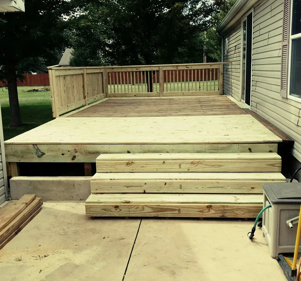 A wooden deck with stairs leading up to it
