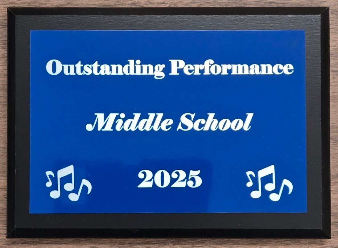 A blue sign that says outstanding performance middle school 2025