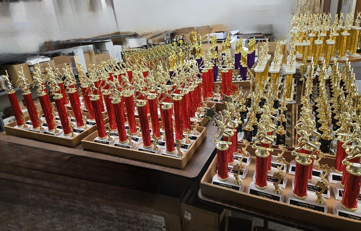 A bunch of trophies are sitting on a table.