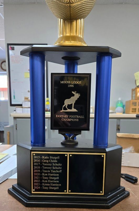 A trophy with a picture of a goat on it
