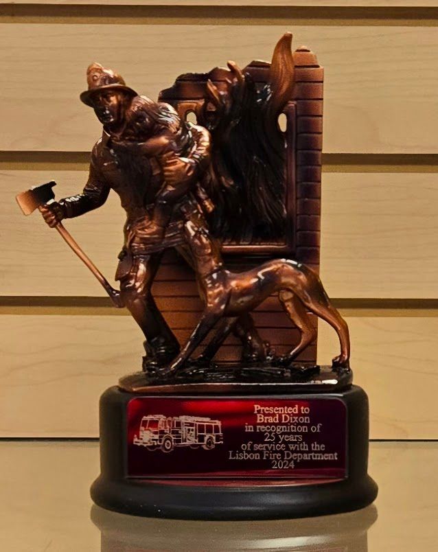 A bronze statue of a fireman carrying a child