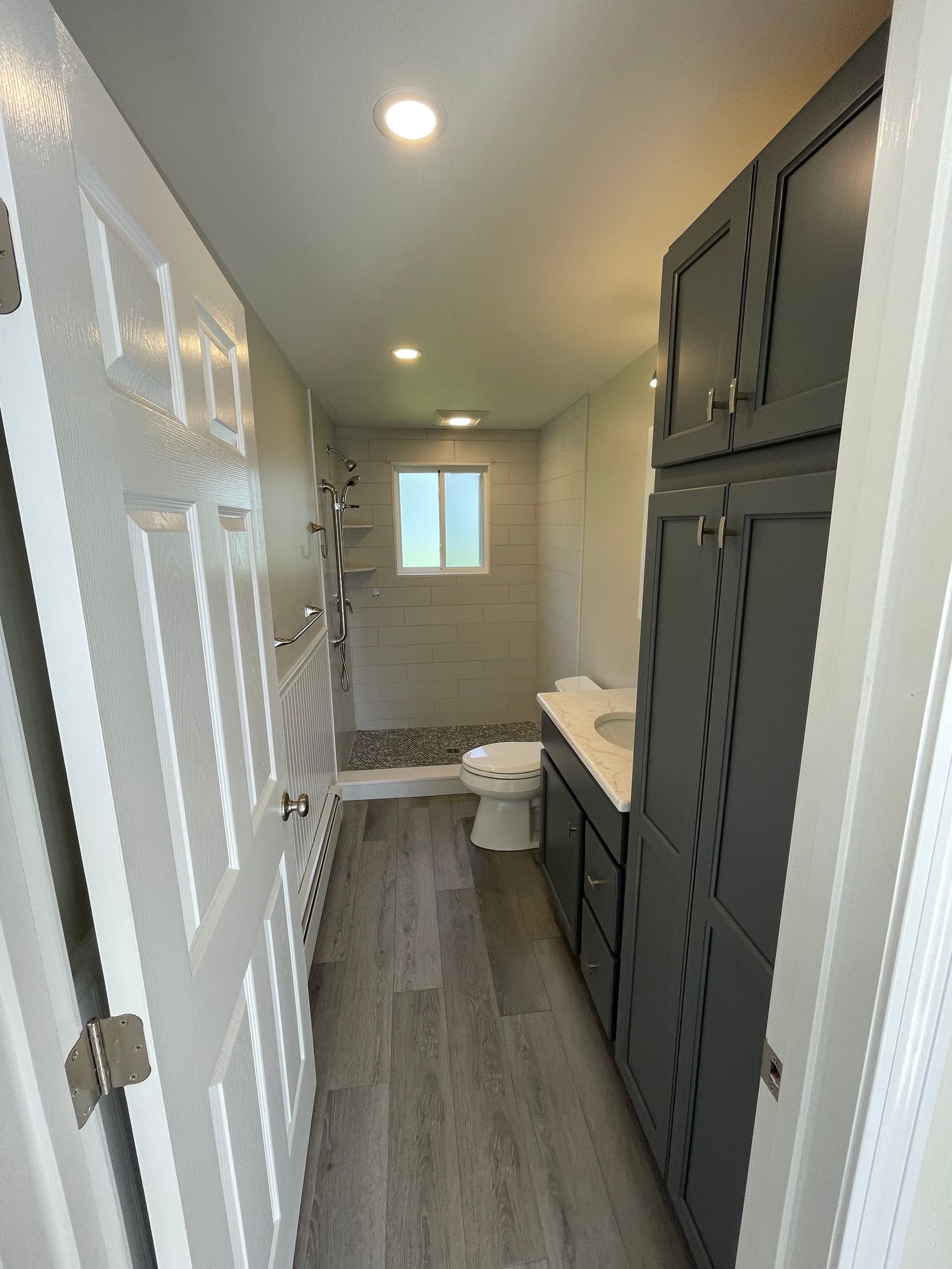 A bathroom with a toilet a sink and a window