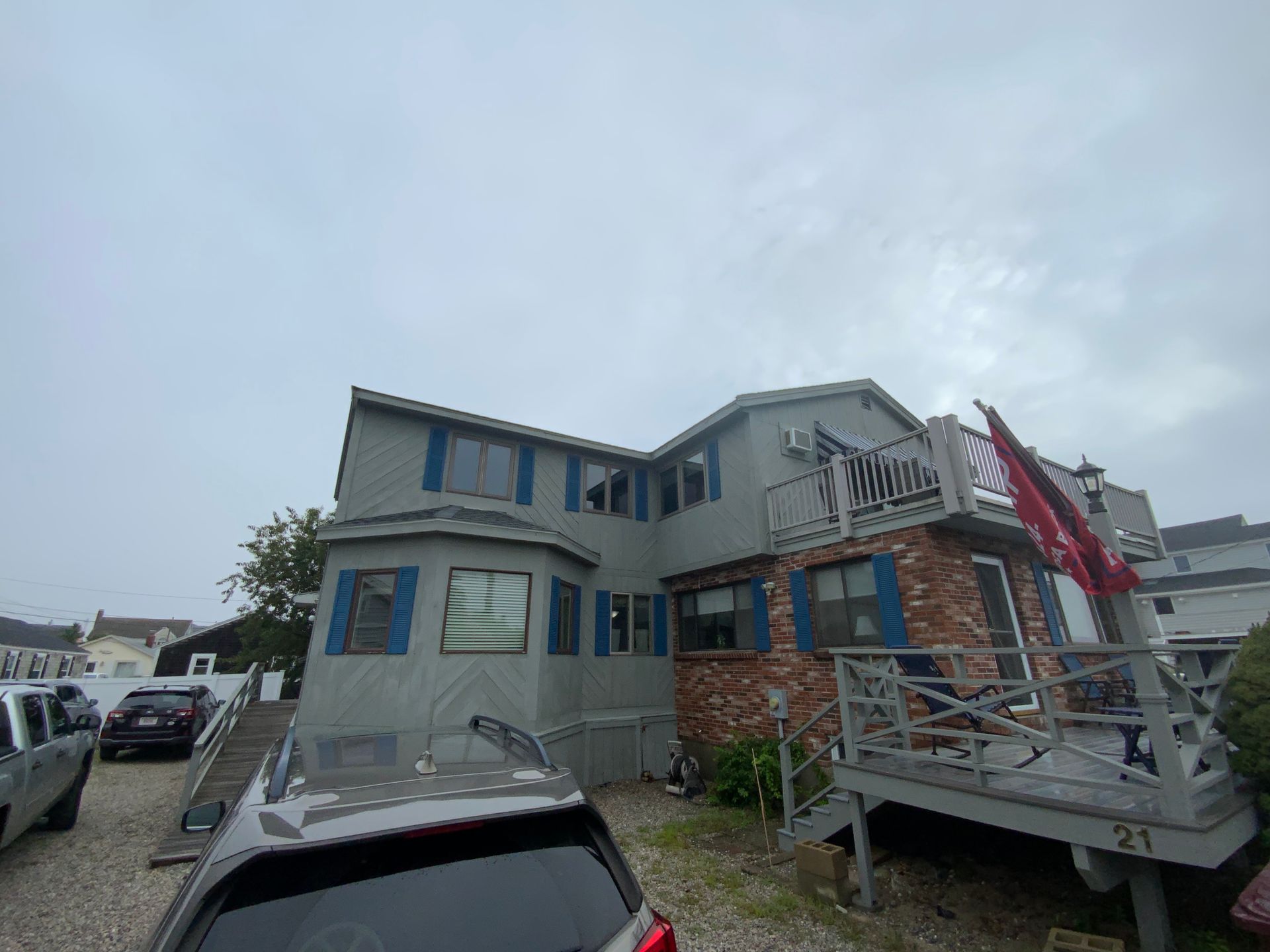 A large house with a car parked in front of it.