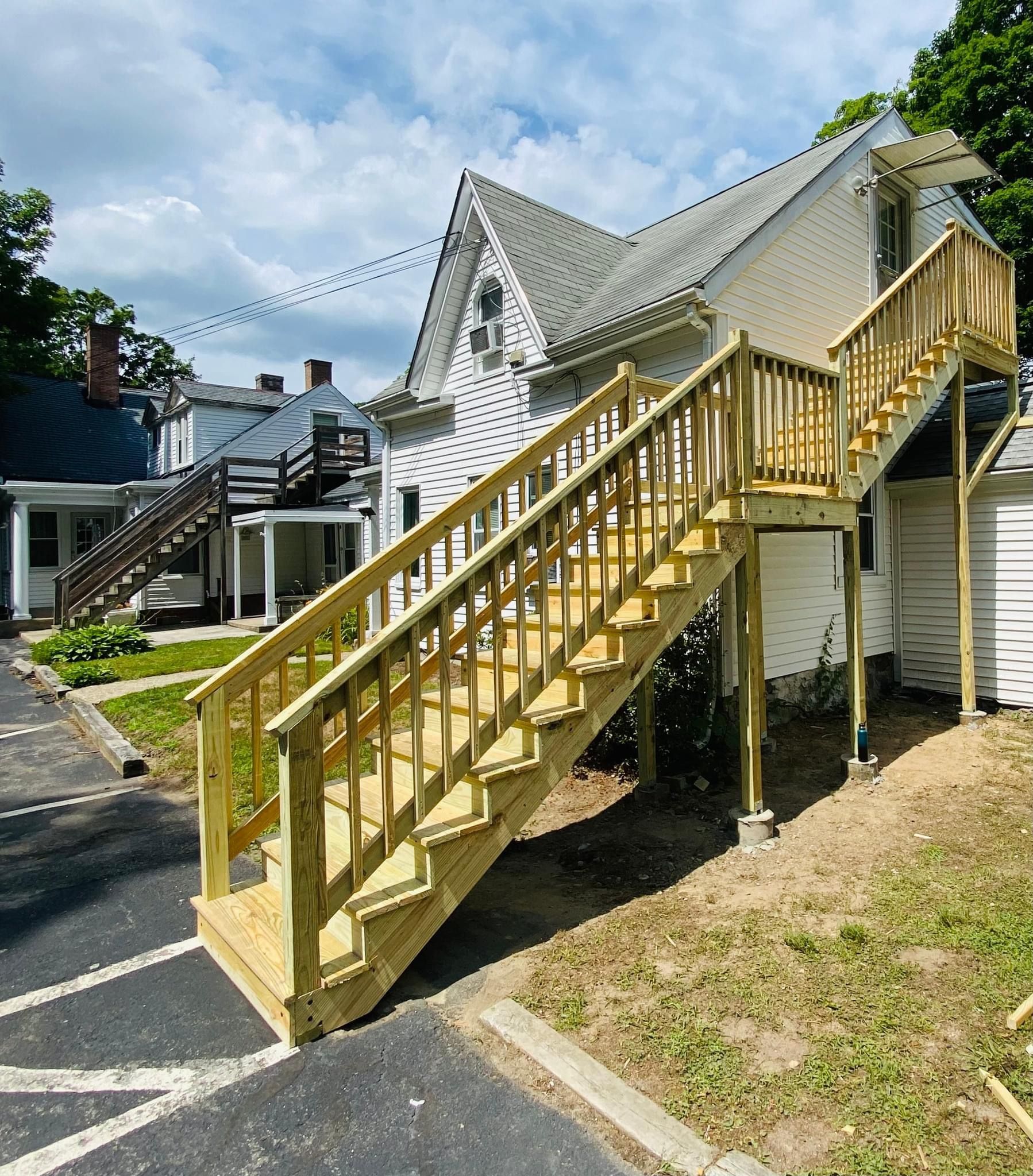a wooden deck with stairs leading up to a house