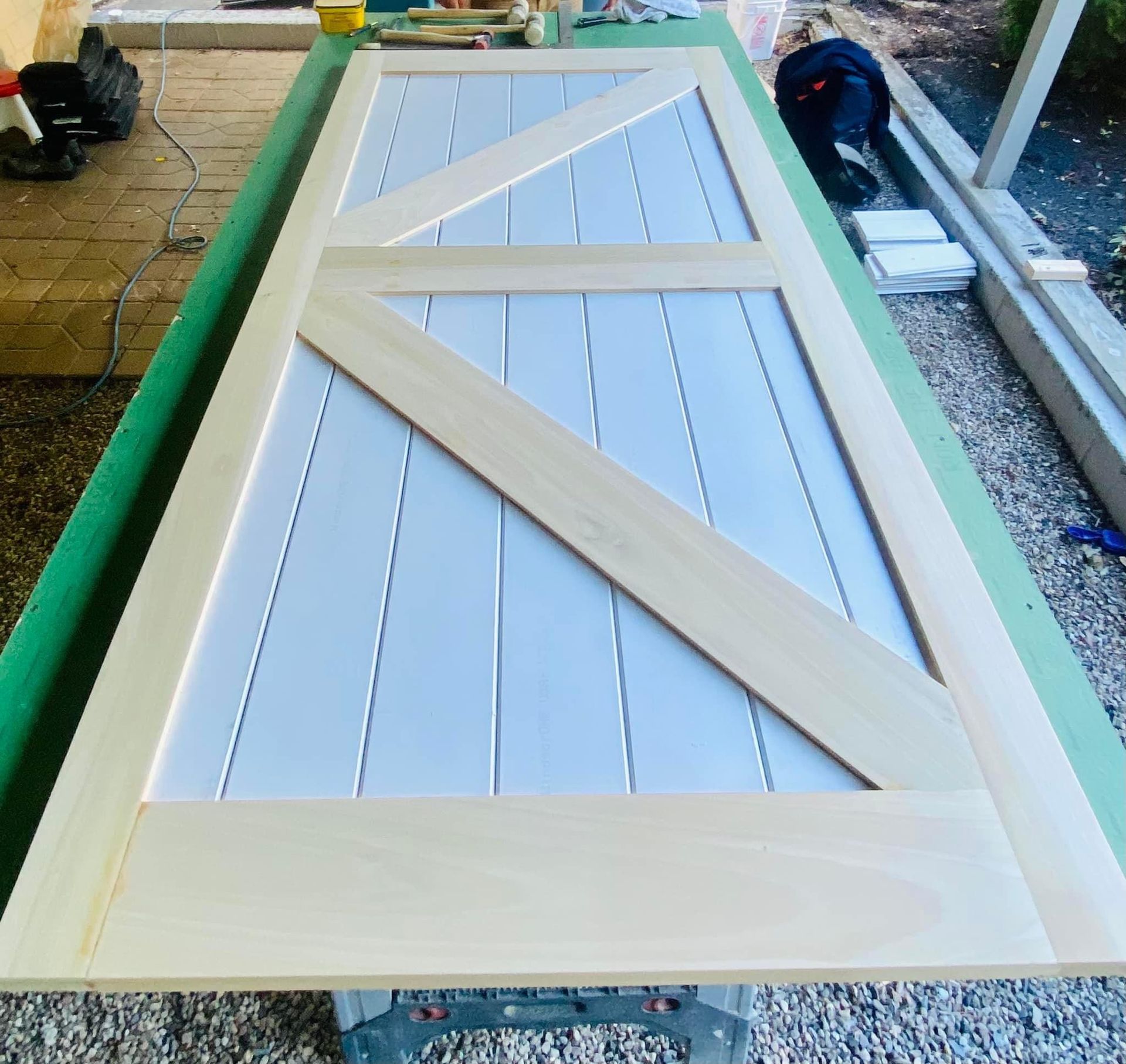 a wooden door is being built on a green table