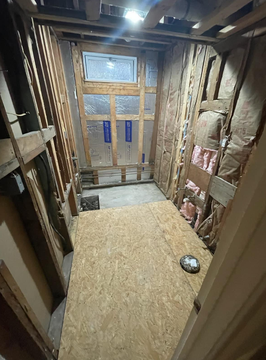 a room with a lot of wooden walls and a window