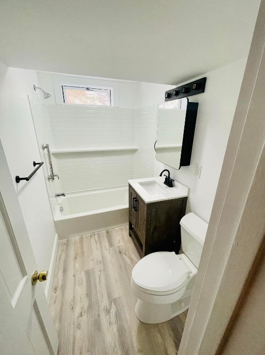 a bathroom with a toilet, sink, and bathtub
