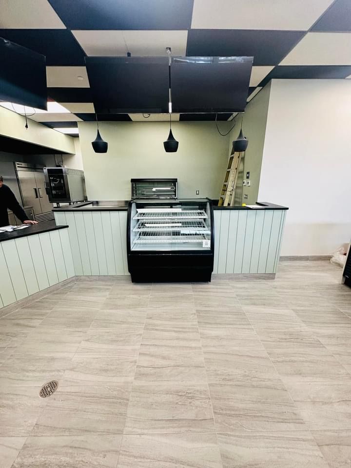 An empty restaurant with a display case in the middle of the room