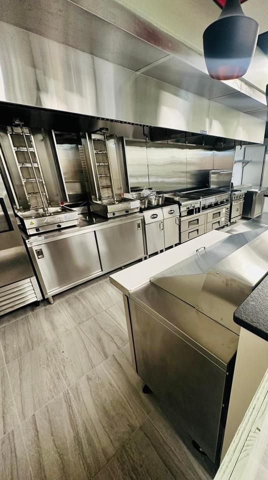 A kitchen with a lot of stainless steel appliances and equipment