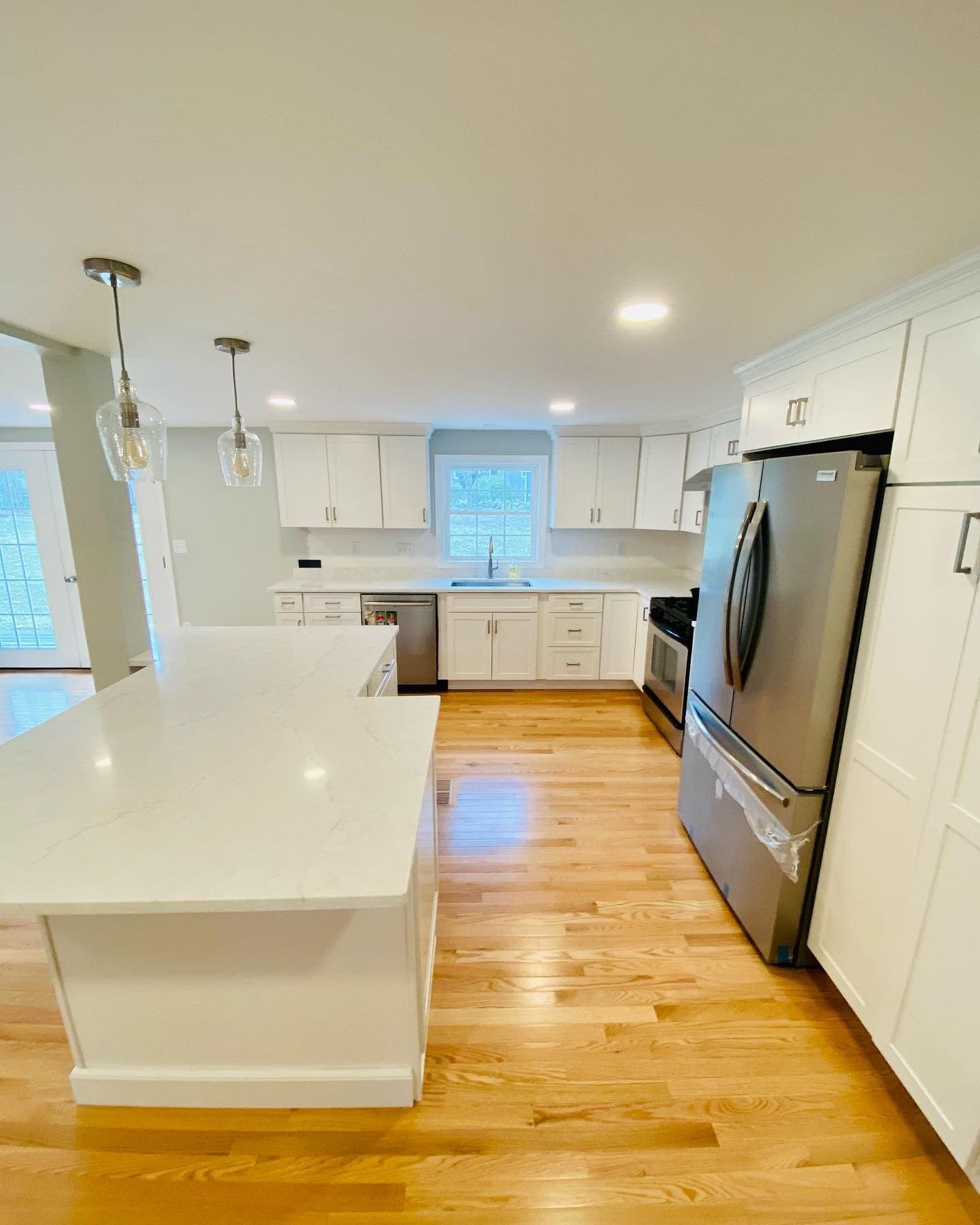 a kitchen with stainless steel appliances and white cabinets