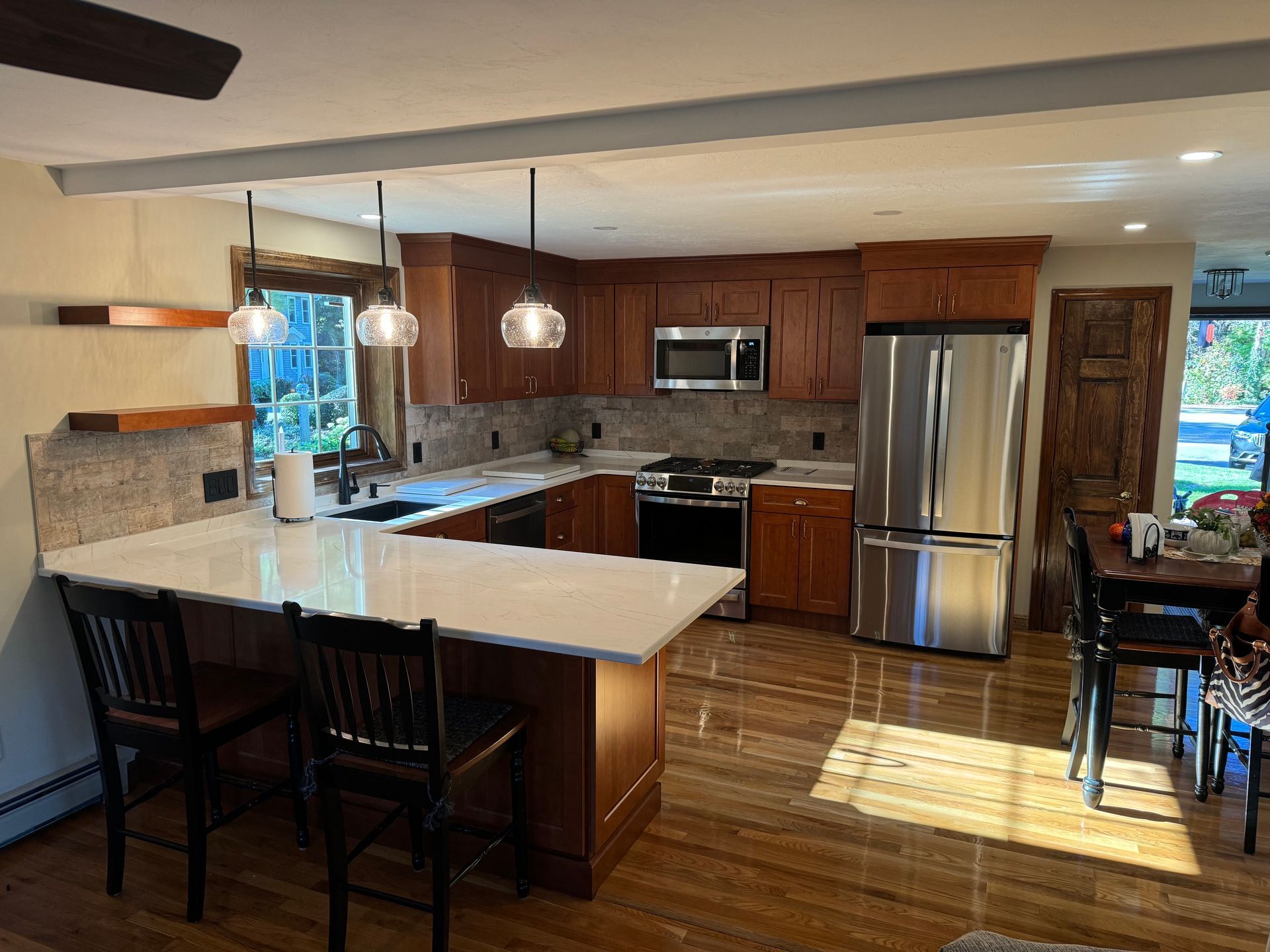 A kitchen with stainless steel appliances and wooden cabinets.
