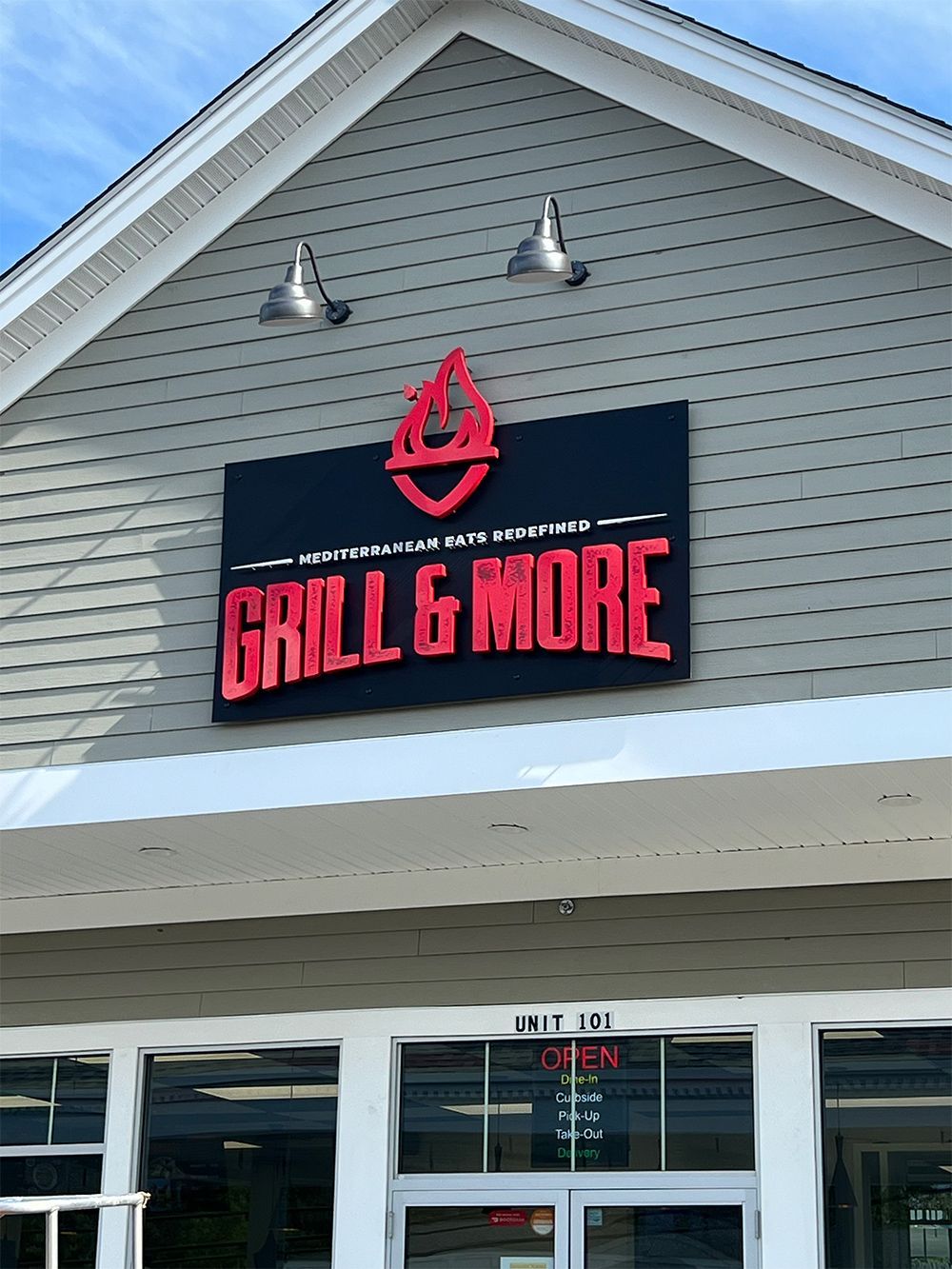 A restaurant with a sign that says grill & more