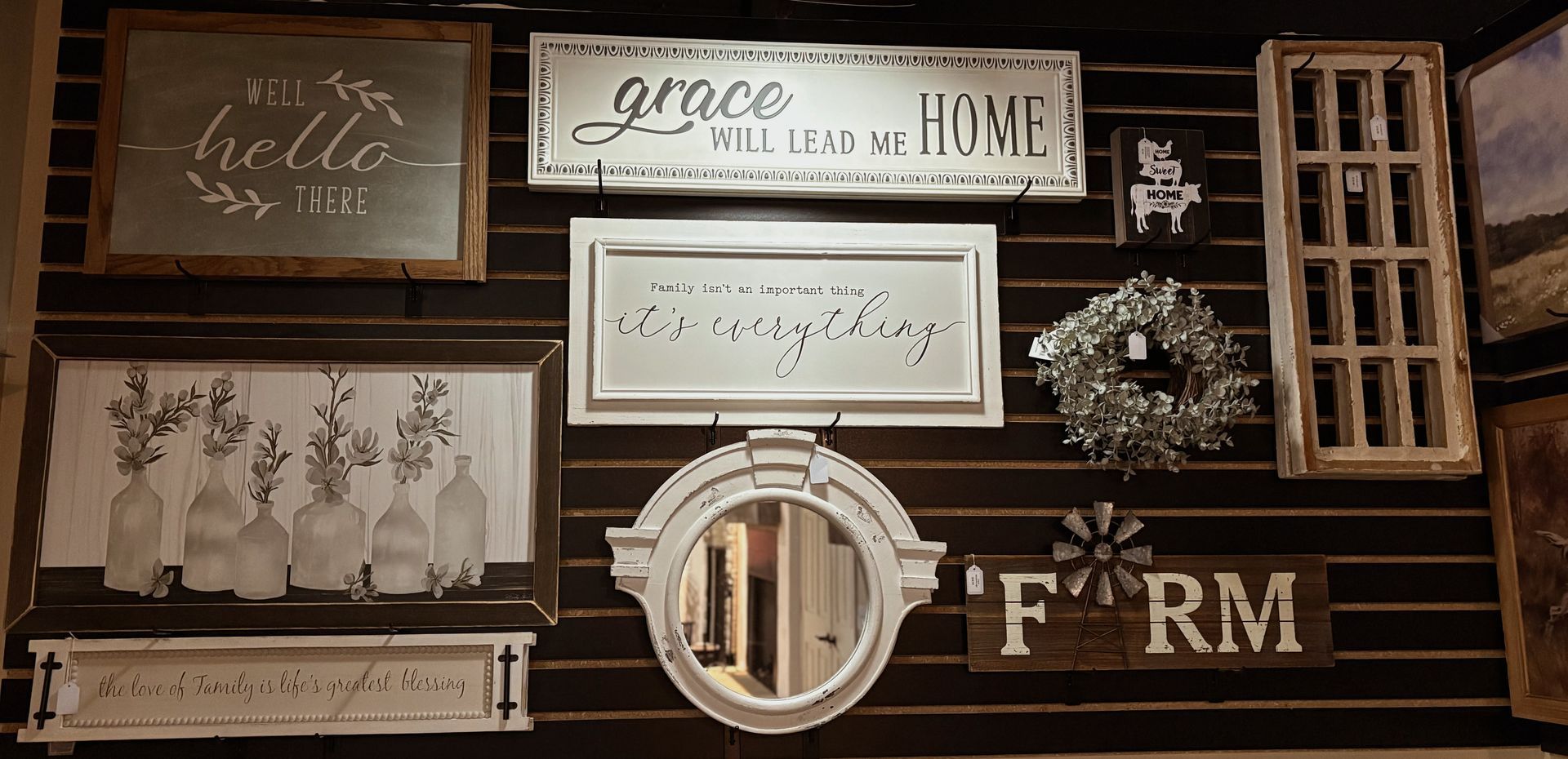 A room with a fireplace and a stack of boxes on a shelf.