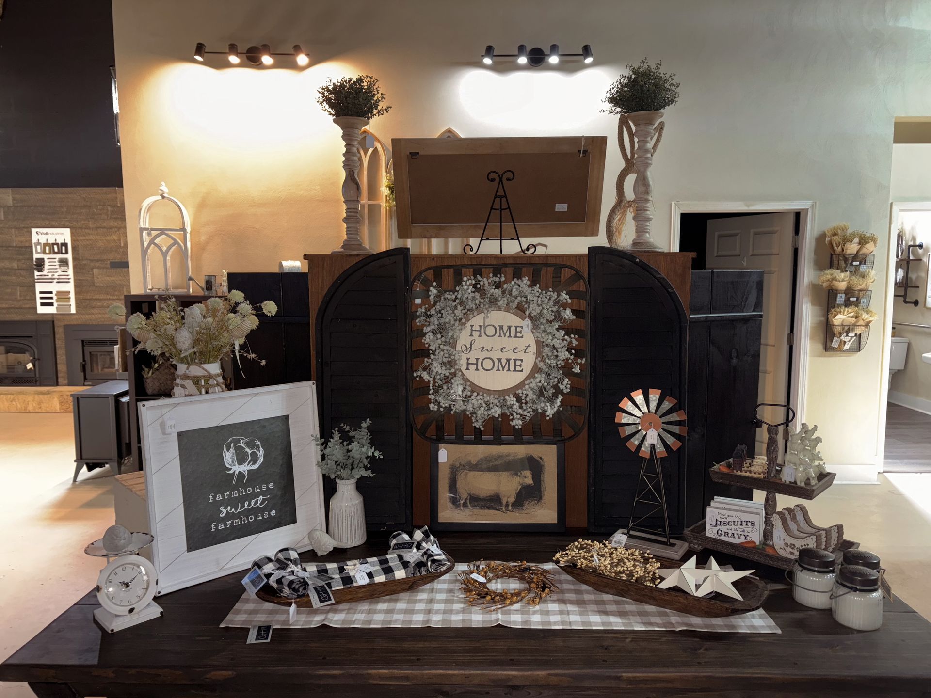 A fireplace with a picture on the mantle and a painting on the wall.