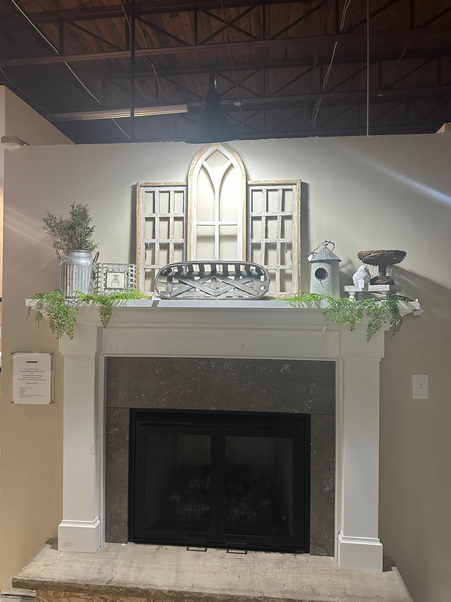 A living room with a fireplace and a mantle decorated with flowers