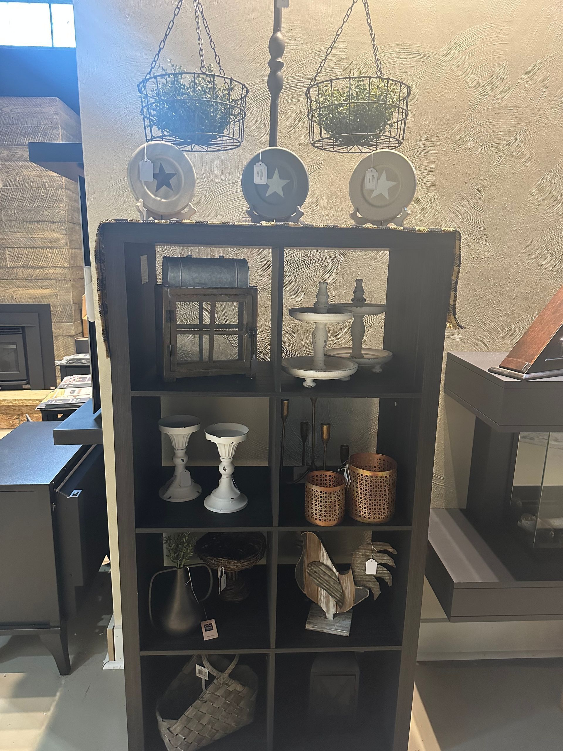 A shelf with a lot of items on it in a room