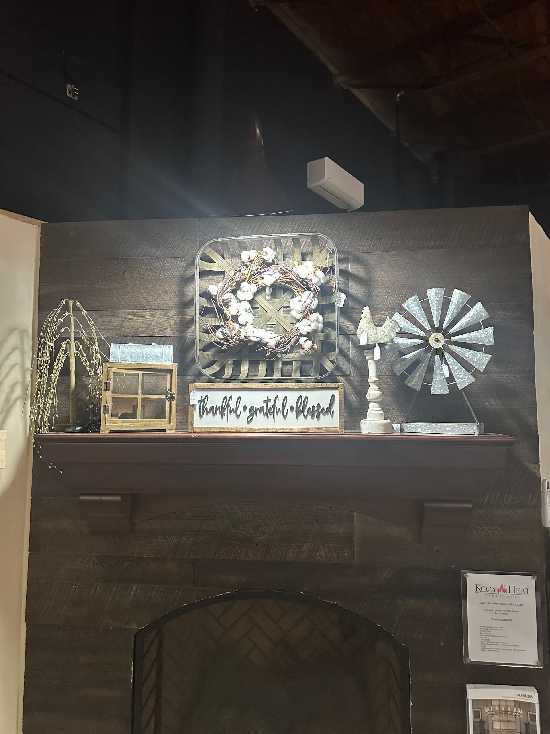 A mantle with a wreath and a windmill on it