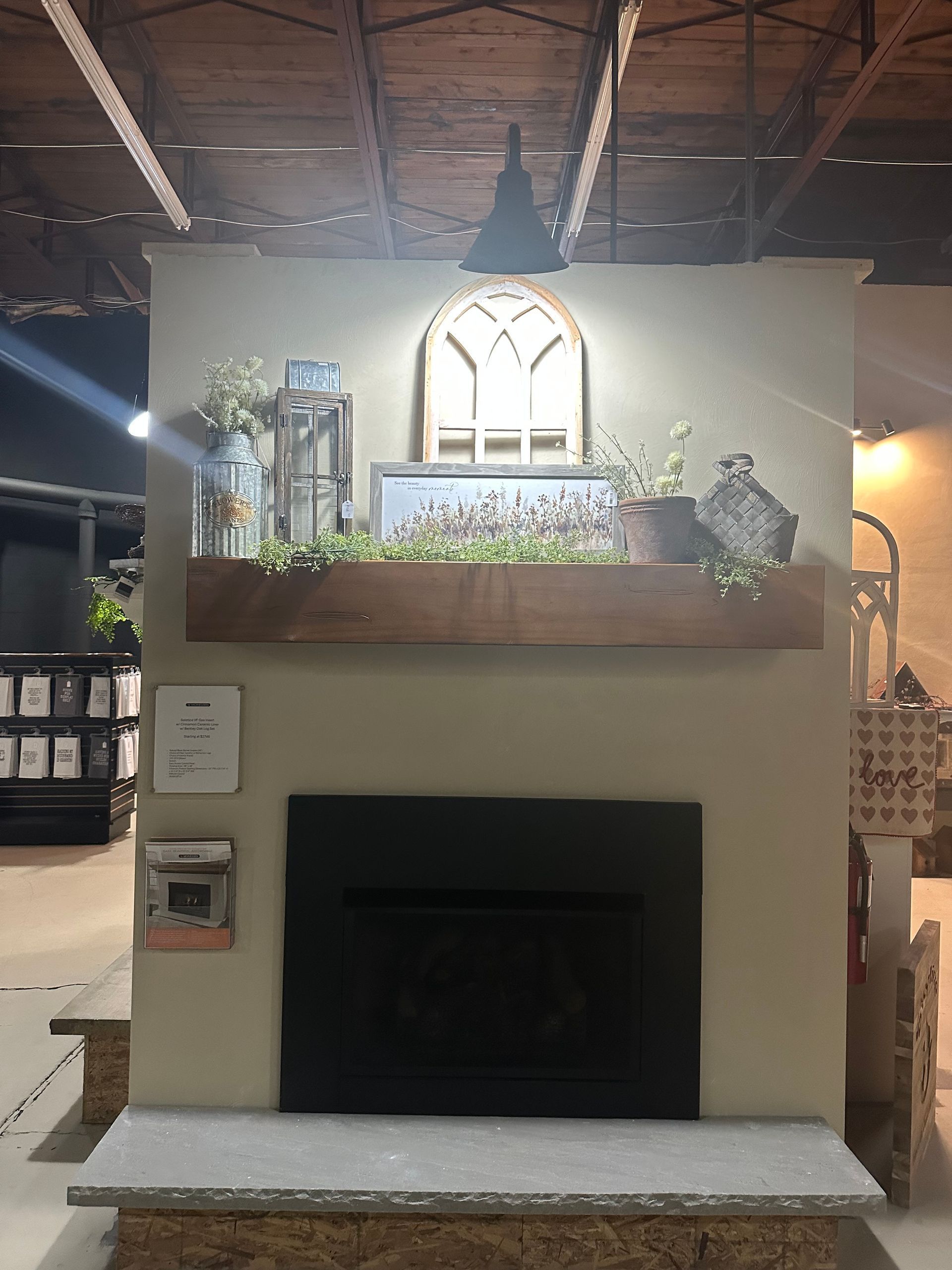 A fireplace with a mantle and a mirror above it